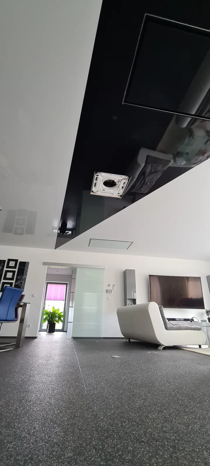 Spanndecke im Wohnzimmer – Schwarz-weiße Spanndecke in einem modernen Wohnraum